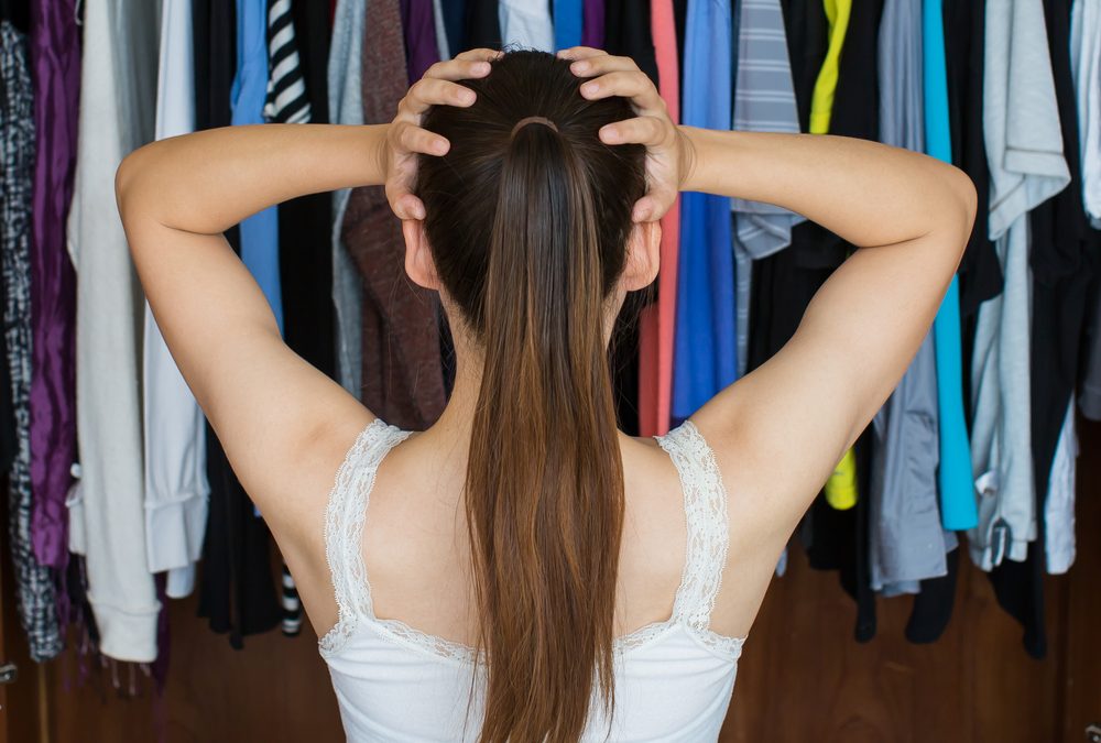 Woman stressed out while picking out an outfit