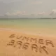 summer break written in the sand